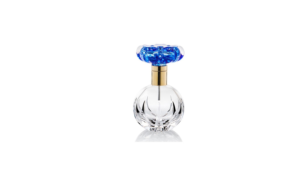 Clear perfume bottle w/ blue flower and gold metal